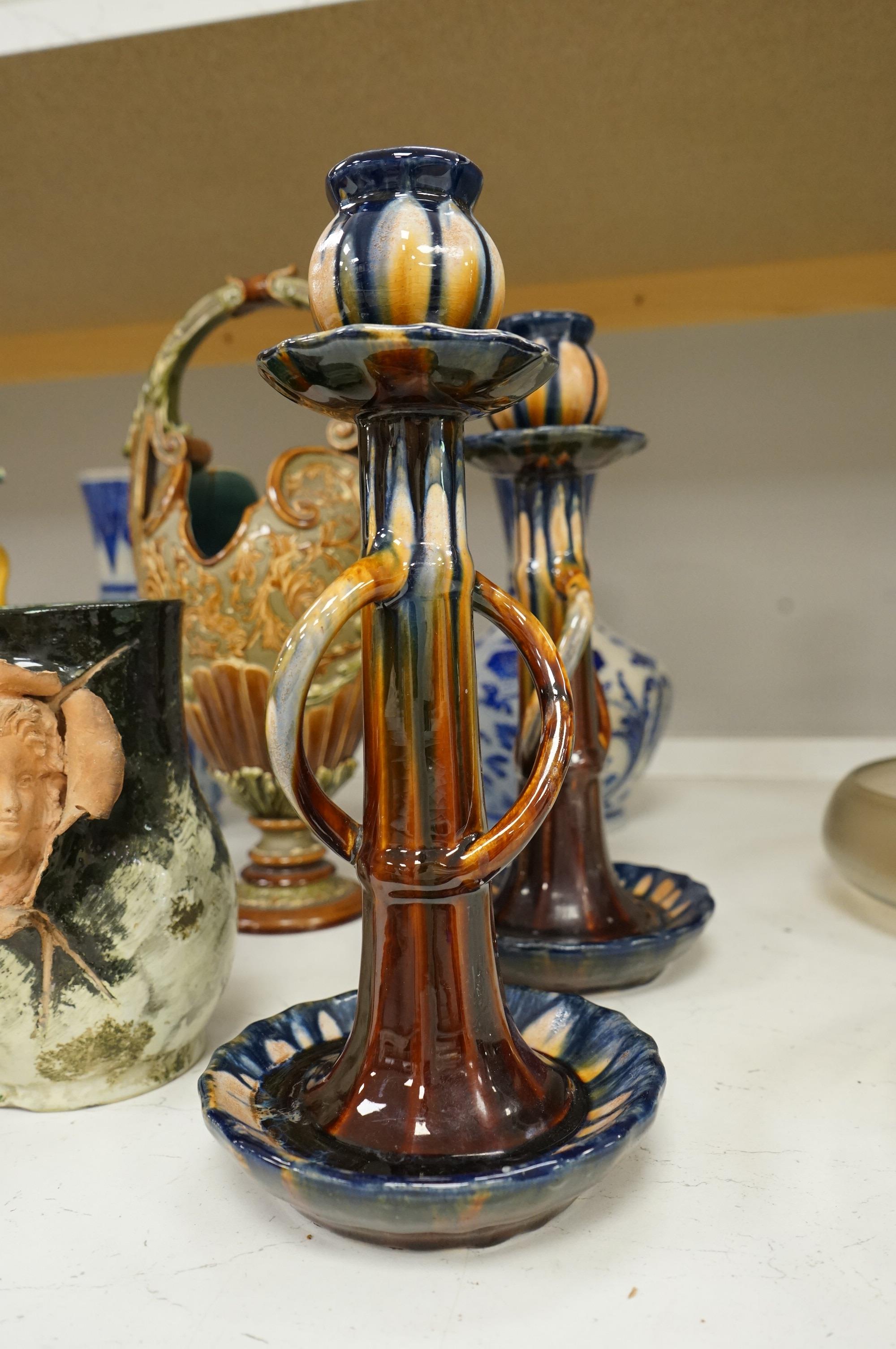 A collection of late 19th century and early 20th century European pottery and stoneware items to include a pair of glazed candlesticks stamped Belgium, largest 36cm high